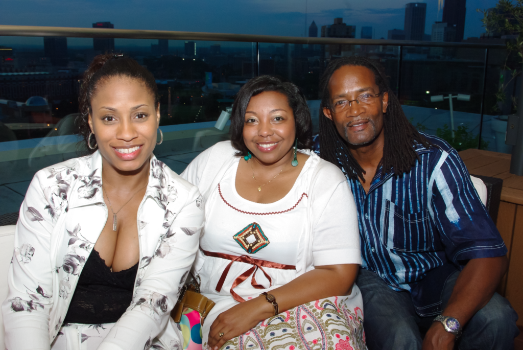 African-American groupwomen posing in front of the Atlanta skyline