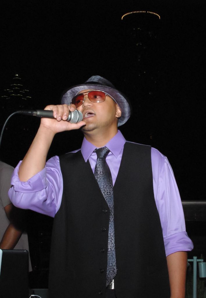 MC on the mic at downtown Atlanta's Glenn Hotel rooftop