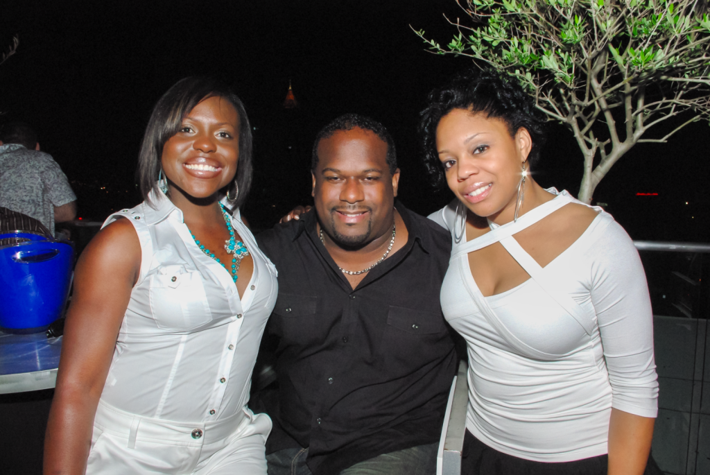 Young adults posing at a rooftop event in Atlanta