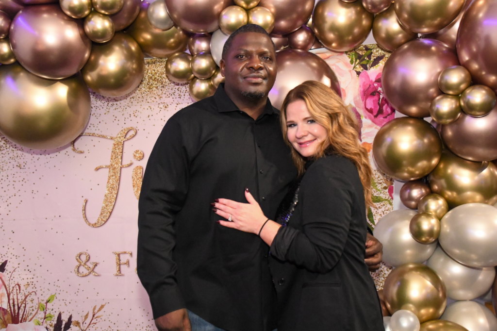 Couple posing in front of a balloon background