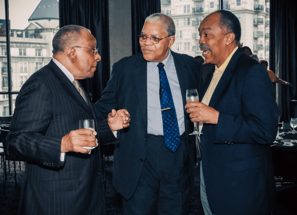 Senior African-American men talking at an event