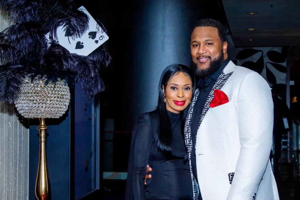 African-American couple posing in front of black and white poker background