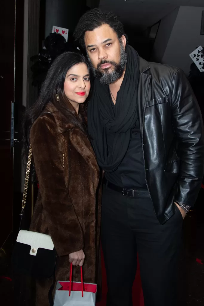 Couple posing in front of black poker background