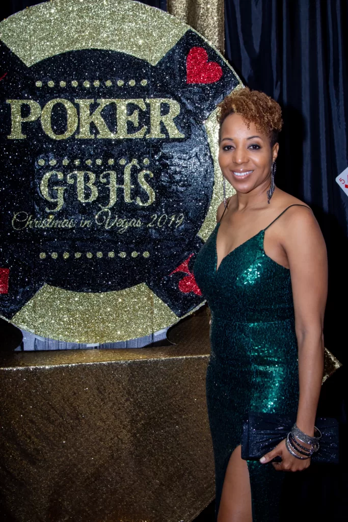 African-American woman posing in front of black and gold poker background